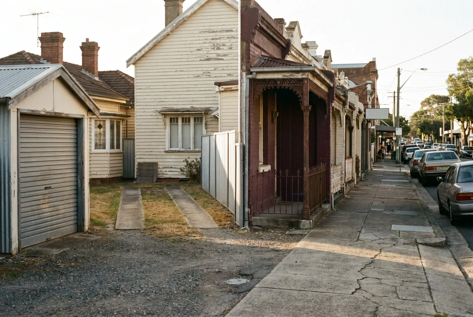 Narrow-fronted cottages close to the footpath on a Hamilton street with a tight side driveway
